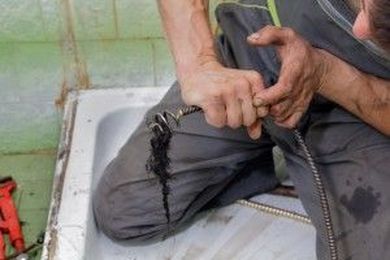 Should I use drain cleaning solutions to unclog my drain?