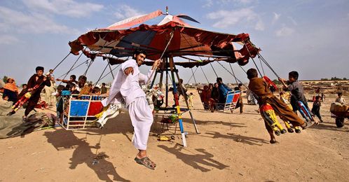 Makeshift amusement parks on the outskirts of Pakistani towns offer good times and hope