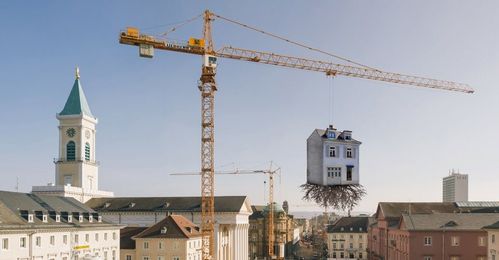 This German Sculpture Looks Like a Crane Uprooted a House