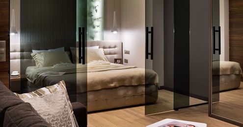 Glass Doors Define The Bedroom In This Small Apartment