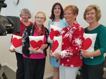 Volunteers make mended heart pillows to heal broken hearts