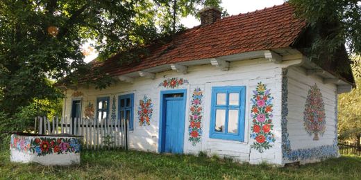 All The Buildings In This Small Town Are Covered In Paintings Of Flowers