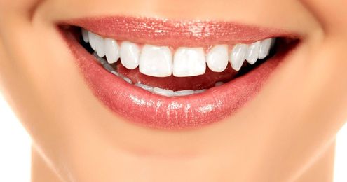 Four Ways That Porcelain Veneers Can Give You The Smile Of A Cover Model