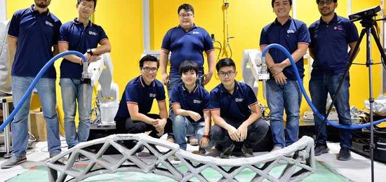 2 robots in tandem create 3D-printed building components