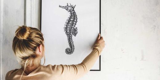 This Fork Trick Makes It Infinitely Easier to Hang Photos On A Wall