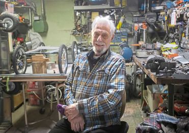 Cars he makes and gives away help this Green Tree man pedal joy